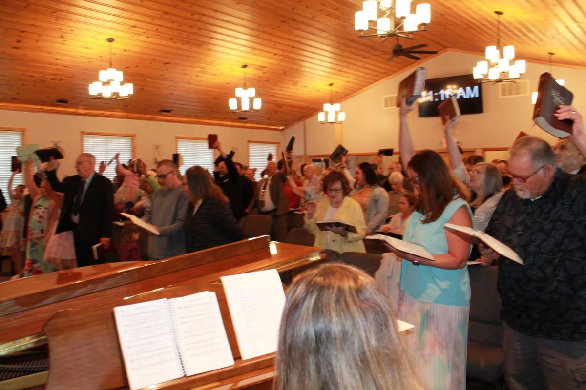 Congregation holding Bibles